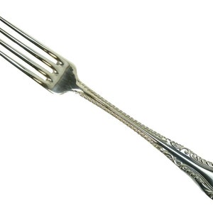 May include: A silver fork with a decorative handle. The fork has four tines and a long, slender handle.