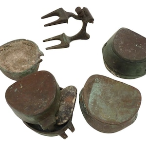May include: A set of five antique bronze dental molds, including a mold for a tooth, a mold for a bridge, and a mold for a crown. The molds are in various shapes and sizes, and they are all in good condition.