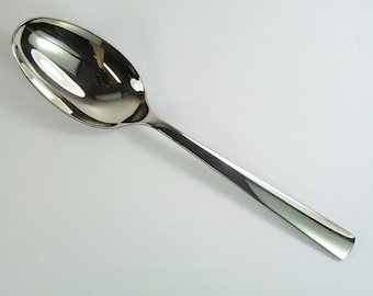 May include: A silver spoon with a rounded bowl and a long, straight handle that tapers to a point.