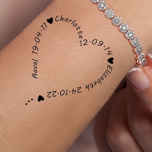 May include: A close-up of a person's wrist with a silver bracelet with small diamonds. The bracelet is inscribed with the names "Charlotte" and "Elizabeth" and the dates "12.09.74", "19.04.77", "24.10.72", and "17.09.74".