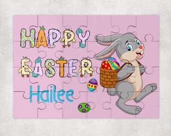 May include: A pink puzzle featuring a cartoon bunny carrying a basket of colorful Easter eggs. The puzzle says "Happy Easter Hailee" in colorful letters.