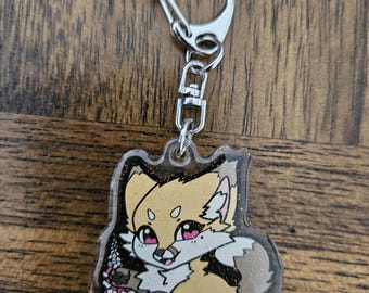 May include: A clear acrylic keychain featuring a cartoon fox holding pink flowers. The fox has a light brown body, a white chest, and pink eyes. The keychain has a silver metal ring.