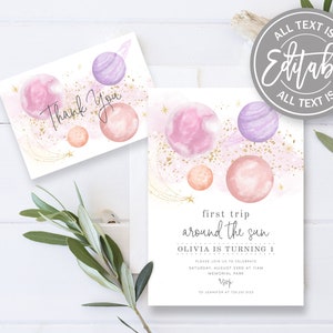 May include: Pink and purple watercolour planets with gold glitter and stars on a white background. The text "first trip around the sun Olivia is turning 1" is printed on the invitation.