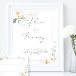 May include: A white card with a floral design and the text "Share a Memory" with instructions to take a card and share a memory of the beloved.  The card is next to a white card with lines for writing and the text "Share a Memory" with a floral design.