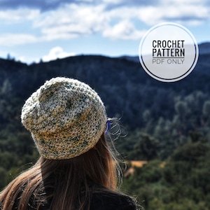 May include: A crocheted beanie hat in a light green and white color combination. The hat is worn by a person standing in front of a mountain range. The text "CROCHET PATTERN PDF ONLY" is visible in a circle.