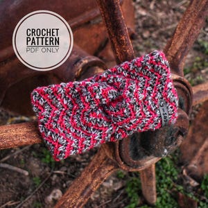 May include: A pink and gray crochet headband with a black tag that says "S&D".