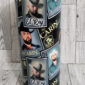 May include: A black and gold tumbler with a repeated pattern of a man wearing a cowboy hat and the words "El Rey" and "Carin Lee" in a gold font.