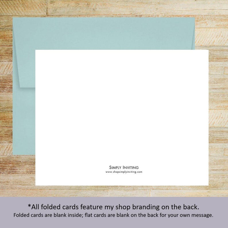 May include: A blank white rectangular card positioned in front of a light blue envelope. The back of the card features the black text SIMPLY INVITING and the website address www.shopsimplyinviting.com centered at the bottom edge.