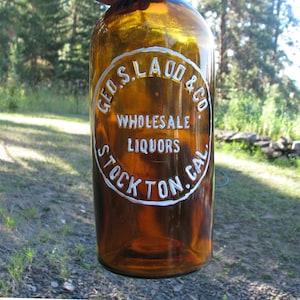 old GEORGE S. LADD Western Whiskey Bottle, STOCKTON California, Wild West, Basement Bar Decor, Pre Prohibition cylinder
