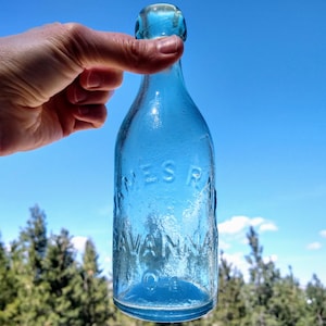 May include: A set of three ceramic mugs with a speckled, matte finish. The mugs are in shades of cream, light gray, and dark gray. Each mug has a simple, minimalist design, perfect for coffee or tea.