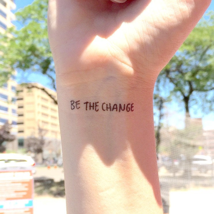 Tattoo that says be the change located on the inner