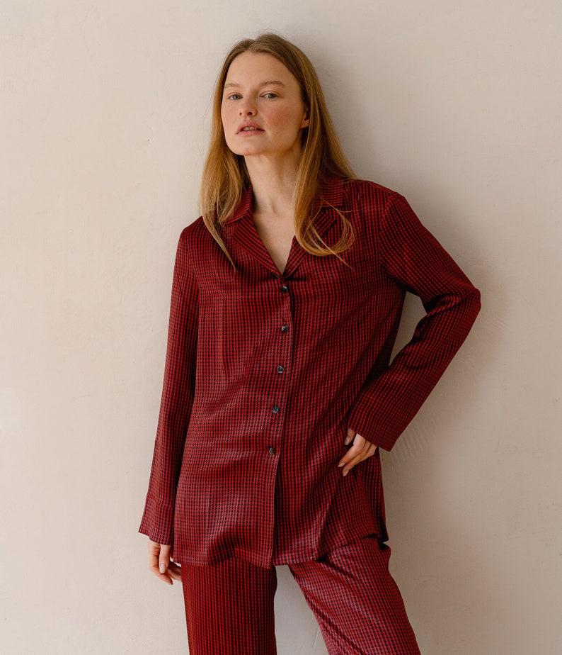 May include: A red and black checked pyjama set with a collared shirt and long trousers.