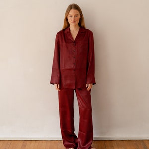 May include: A red and black checked pyjama set with a collared shirt and long trousers.