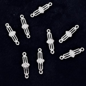 925 Sterling Silver Elegant Connector with 2 Loops   Size: approx 15mm long x 3mm wide Centre flower approx 5mm x 1 diameter.