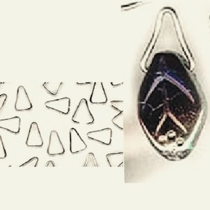 May include: A close-up of a silver triangle-shaped metal ring. The ring is on a white background. There are many other silver triangle-shaped metal rings in the background.