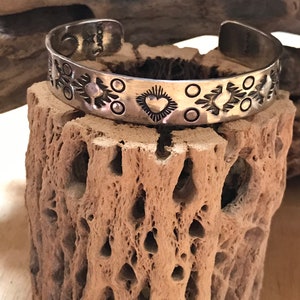 Handmade,hammered sterling silver cuff bracelet with heart motif. Southwest style.