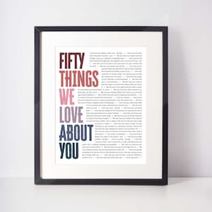 May include: Framed print with the text "FIFTY THINGS WE LOVE ABOUT YOU" in various colors. The text is arranged in a vertical format, with a black frame surrounding the print. The print is a sentimental gift.