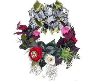 May include: A Halloween wreath with a variety of artificial flowers and foliage. The wreath features a large red rose with an eye in the center, a white flower with an eye, and a large bow with a skull and spiderweb pattern.