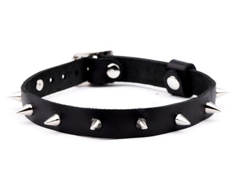 May include: Black leather choker with silver metal spikes.