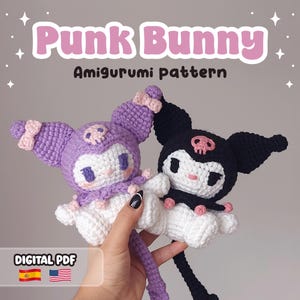 May include: Two crocheted amigurumi bunnies, one purple and one black, with skull accents. The text "Punk Bunny Amigurumi pattern" is displayed above the bunnies. The phrase "DIGITAL PDF" is at the bottom, along with the Spanish and American flags.