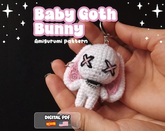 May include: A white crocheted amigurumi bunny keychain with pink inner ears, black X-shaped eyes, and a silver-colored chain collar. The text Baby Goth Bunny Amigurumi pattern and DIGITAL PDF is visible on the image along with star icons.