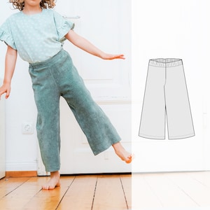 May include: A young person wearing a green corduroy wide-leg pant with a white floral print top. A line drawing of a wide-leg pant is shown on the right side of the image.