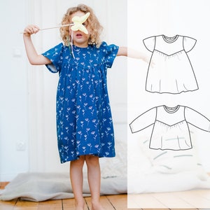 May include: A blue dress with a floral pattern, worn by a child holding a yellow butterfly toy. The dress has short sleeves and a gathered skirt. A line drawing of a similar dress is shown next to the child.