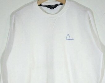 May include: White long-sleeve sweatshirt with a blue Head logo on the front.