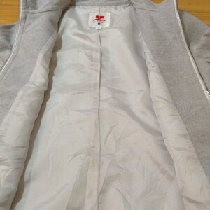 May include: A grey zipped jacket with a white lining. The jacket has a red label with the text "SOUTHPOLE" on it.