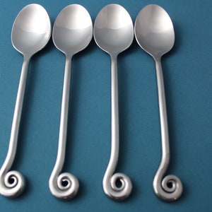 4 Teaspoons Pottery Barn PBN17 Glossy Stainless China Coiled 7 3/8&quot;