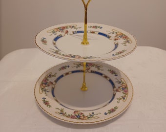 two tier cake stand with flowers and gold trim