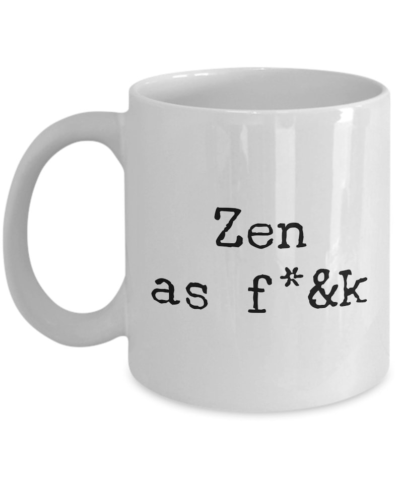 May include: White ceramic mug with a black text that reads "Zen as f*&k". The mug has a curved handle and a simple, clean design. Perfect for coffee, tea, or any favorite beverage.