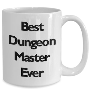 May include: White ceramic coffee mug with black text that reads "Best Dungeon Master Ever".