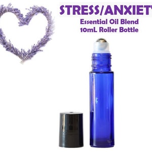 May include: Blue glass roller bottle with a silver roller ball. The bottle is labeled "Stress/Anxiety Essential Oil Blend 10mL Roller Bottle".