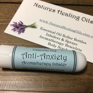 May include: A white plastic aromatherapy inhaler with a blue label that reads "Anti-Anxiety Aromatherapy Inhaler". The label also includes the instructions "USE: Holding one nostril closed."