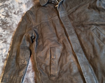 May include: A black leather jacket with a zipper closure and a collar. The jacket has two pockets on the front and a single pocket on the left sleeve.