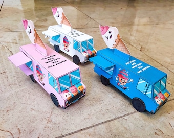 May include: Three paper ice cream truck models, one pink, one white, and one blue. Each truck has a smiling ice cream cone on top and a cartoon ice cream character on the side. The text on the trucks reads "Thank you for chilling with us!"