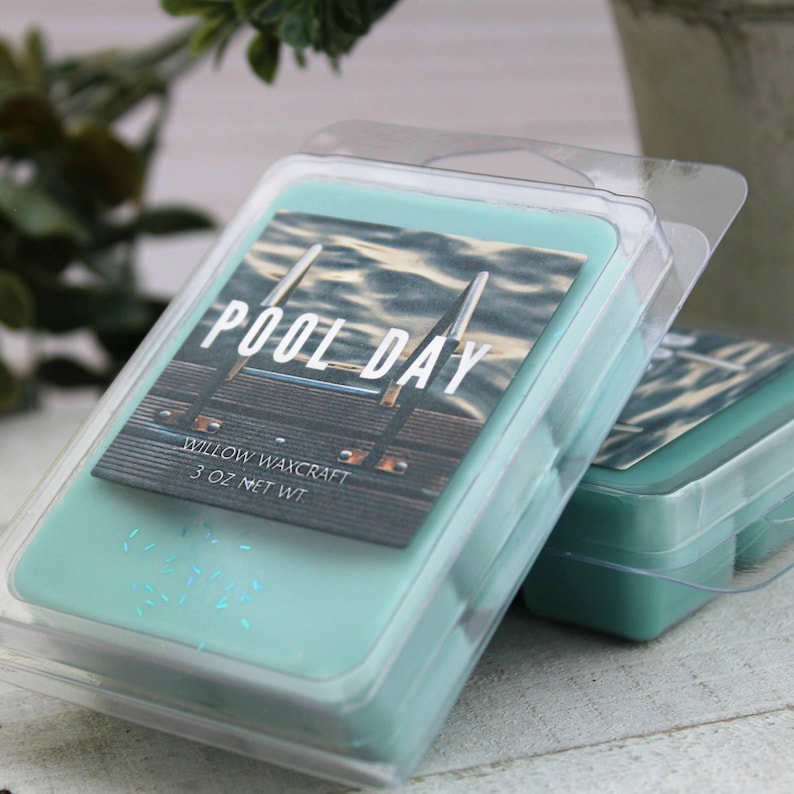 May include: Two teal-colored wax melt packages in clear plastic containers. Each package has a label with the words "POOL DAY" and a picture of a pool. The label also says "WILLOW WAXCRAFT 3 OZ NET WT".