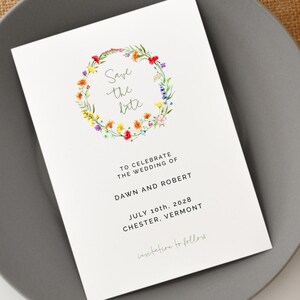 May include: Save the date card with a floral wreath illustration. The text reads "Save the date" and includes the names Dawn and Robert, the date July 10th, 2028, and the location Chester, Vermont.