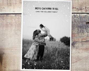 May include: Black and white Christmas card with the text "Merry Christmas to All" and "Love, The Callaway Family." The card features a family in a field, with a parent holding a child up in the air.