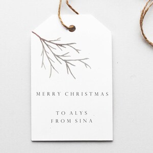 May include: White gift tag with a gray twig illustration. The tag says "Merry Christmas" and "To Alys From Sina".