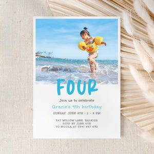 May include: A birthday invitation with a photo of a child in a yellow life vest playing in the ocean. The text on the invitation reads "FOUR, Join us to celebrate Gracie's 4th birthday, Sunday, June 8th 2-4 PM, 547 Willow Lane, Raleigh, RSVP by June 6th, To Nicola at 0341 857 632".