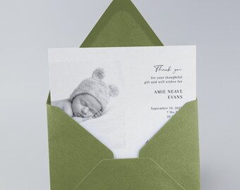 May include: A thank you card with a black and white photo of a baby wearing a knitted hat with bear ears. The card reads "Thank you for your thoughtful gift and well wishes for Amie Neave Evans, September 10, 2021".