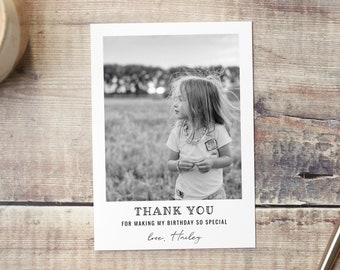 May include: Black and white photo thank you card with a girl in a field. The card says "Thank you for making my birthday so special. Love, Hailey."