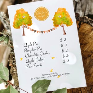 May include: A menu with watercolour illustrations of autumn trees and a banner. The menu lists apple pie, pumpkin pie, chocolate cookies, apple cider, and pear punch. The text "Ask for a sample" is in a circle at the top.