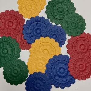 May include: Assortment of decorative paper circles with scalloped edges and embossed floral designs in shades of red, green, blue, and yellow.