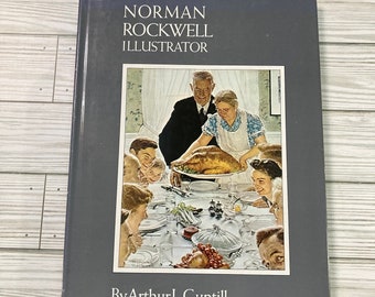 May include: A vintage book titled "Norman Rockwell Illustrator" by Arthur L. Guptill, featuring a cover illustration of a family gathered around a table for a Thanksgiving meal. The illustration depicts a man carving a turkey while a woman holds a platter of food. The family is smiling and enjoying the meal.
