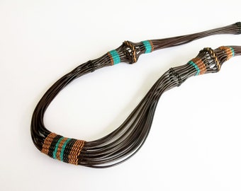 Long XXL ethnic chic contemporary necklace in braided leather