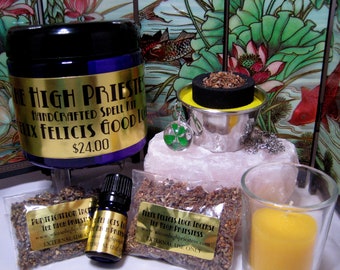May include: A spell kit for good luck, featuring a purple jar labeled "The High Priestess Handcrafted Spell Kit - Felix Felicis Good Luck $24.00", a small bottle of oil, a bag of incense labeled "Felix Felicis Luck Incense The High Priestess", a small candle, and a silver bowl with a black charcoal disc and a green four-leaf clover charm.