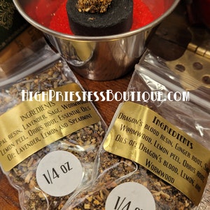 May include: Two small clear plastic bags filled with dried herbs and labeled with gold text. The bags are labeled "Ingredients" and list the ingredients for each blend. The bags are labeled with a white circle that says "1/4 oz".